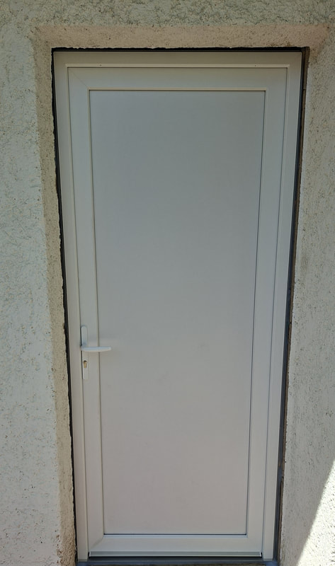 Après travaux : porte PVC blanche neuve posée sur la même ouverture à Clermont-l'Hérault